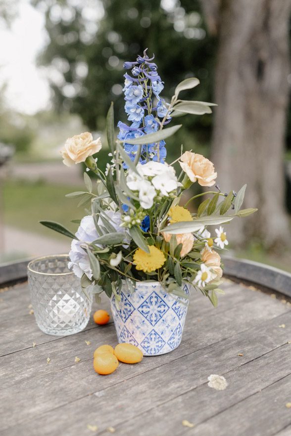 Blau-Weiße Deko-Arrangements als Deko auf Weinfässern