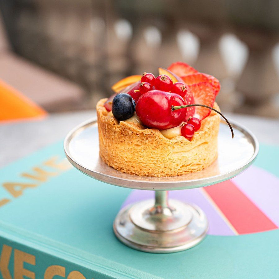 Eventplanung Frankfurt: Früchtetörtchen mit Kirschen und Beeren auf einer silbernen Etagere